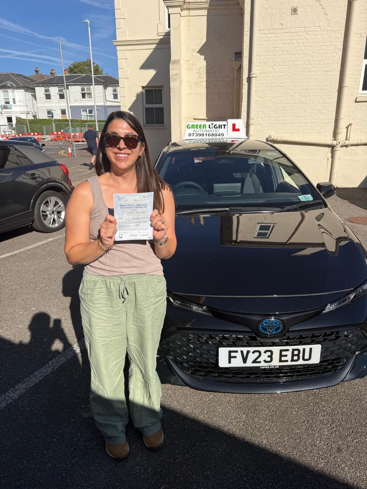 Learner holding a pass certificate
