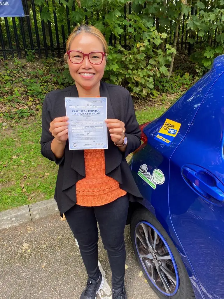 Learner celebrating with her driving test pass certificate